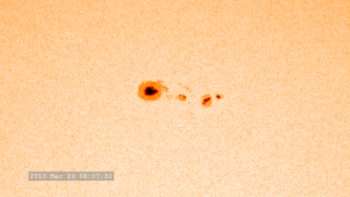 Sunspots, dark areas on the solar surface, contain strong magnetic fields that are constantly shifting. A moderate-sized sunspot is about as large as the Earth. Sunspots form and dissipate over periods of days or weeks. They occur when strong magnetic fields emerge through the solar surface and allow the area to cool slightly; this area appears as a dark spot in contrast with the very bright photosphere of the sun. The rotation of these sunspots can be seen on the solar surface.

 Groups of sunspots, especially those with complex magnetic field configurations, are often the sites of solar flares. The average number of sunspots  regularly waxes and wanes in an 11-year (on average) solar or sunspot cycle.