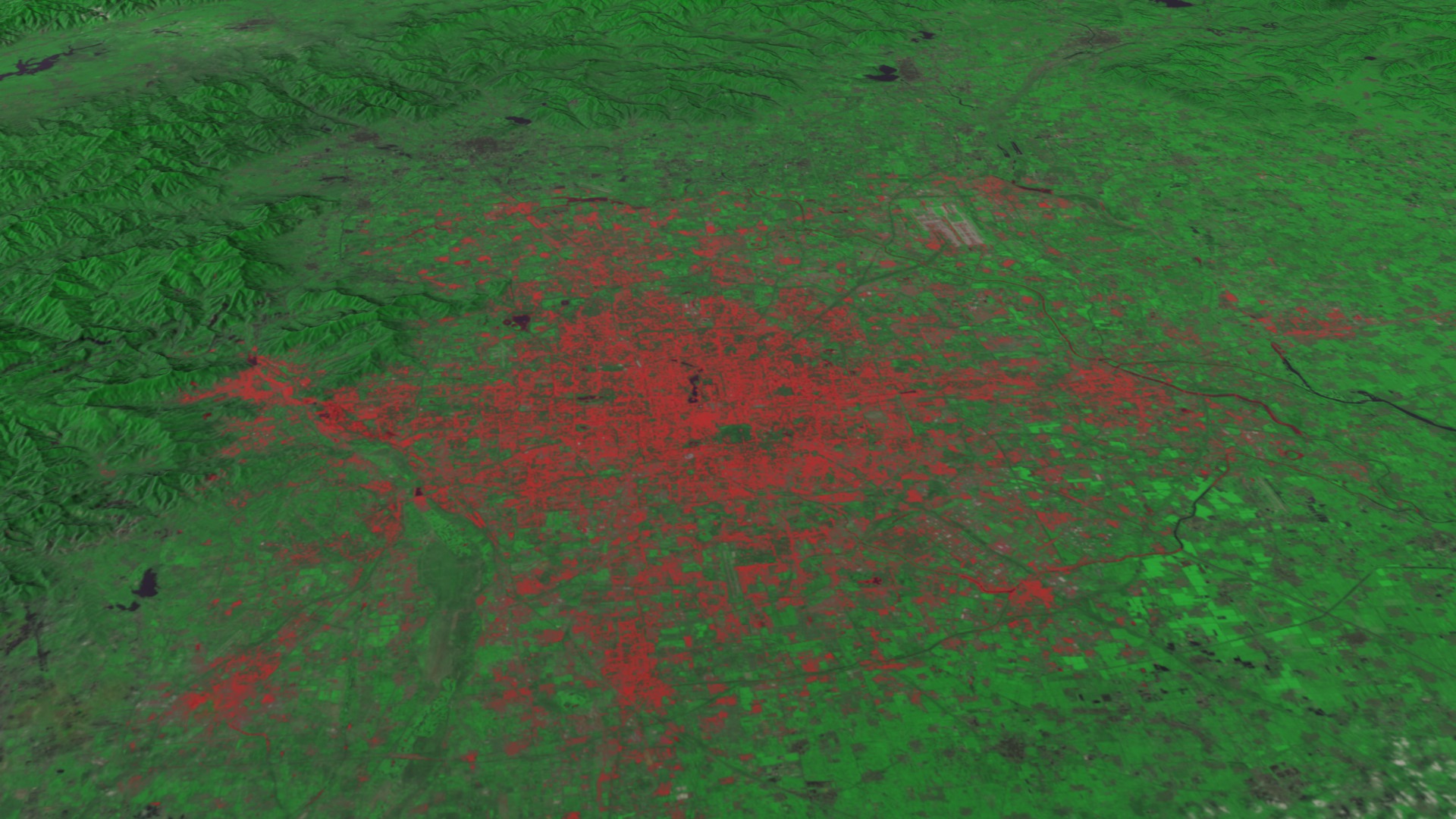 Animation zooming down to Beijing, China in 1978 via Landsat-3.  The data then dissolves to Beijing in 2010 through the sensors of Landsat-5.  The red areas are non-vegetated urban areas.