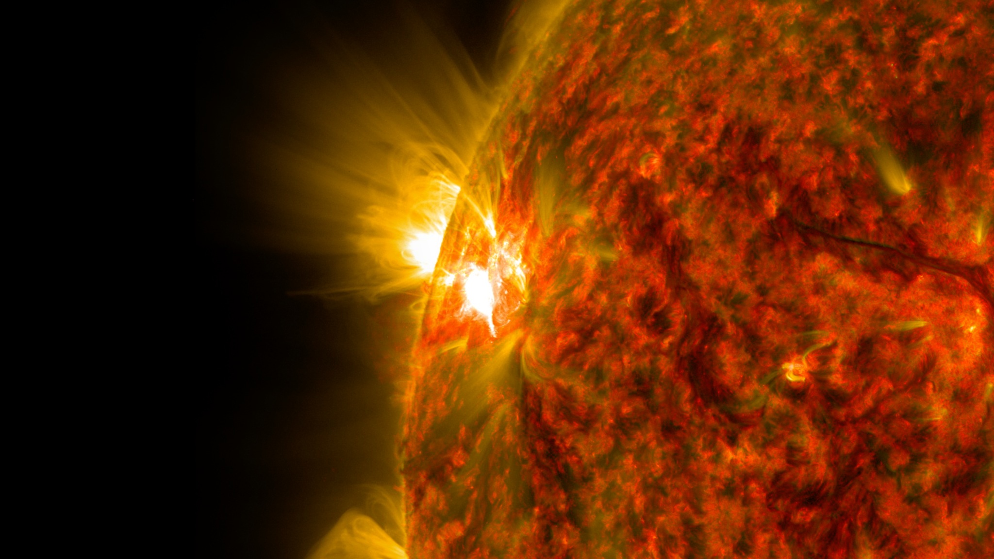 An active region on the sun erupted with a mid-level flare on Nov. 5, 2014, as seen in the bright light of this image captured by NASA's Solar Dynamics Observatory. This image shows extreme ultraviolet light that highlights the hot solar material in the sun's atmosphere. Shown here with the Earth to scale.Credit: NASA/GSFC/SDO