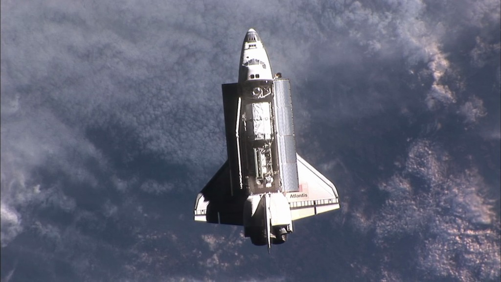 Video of space shuttle over clouds from ISS.