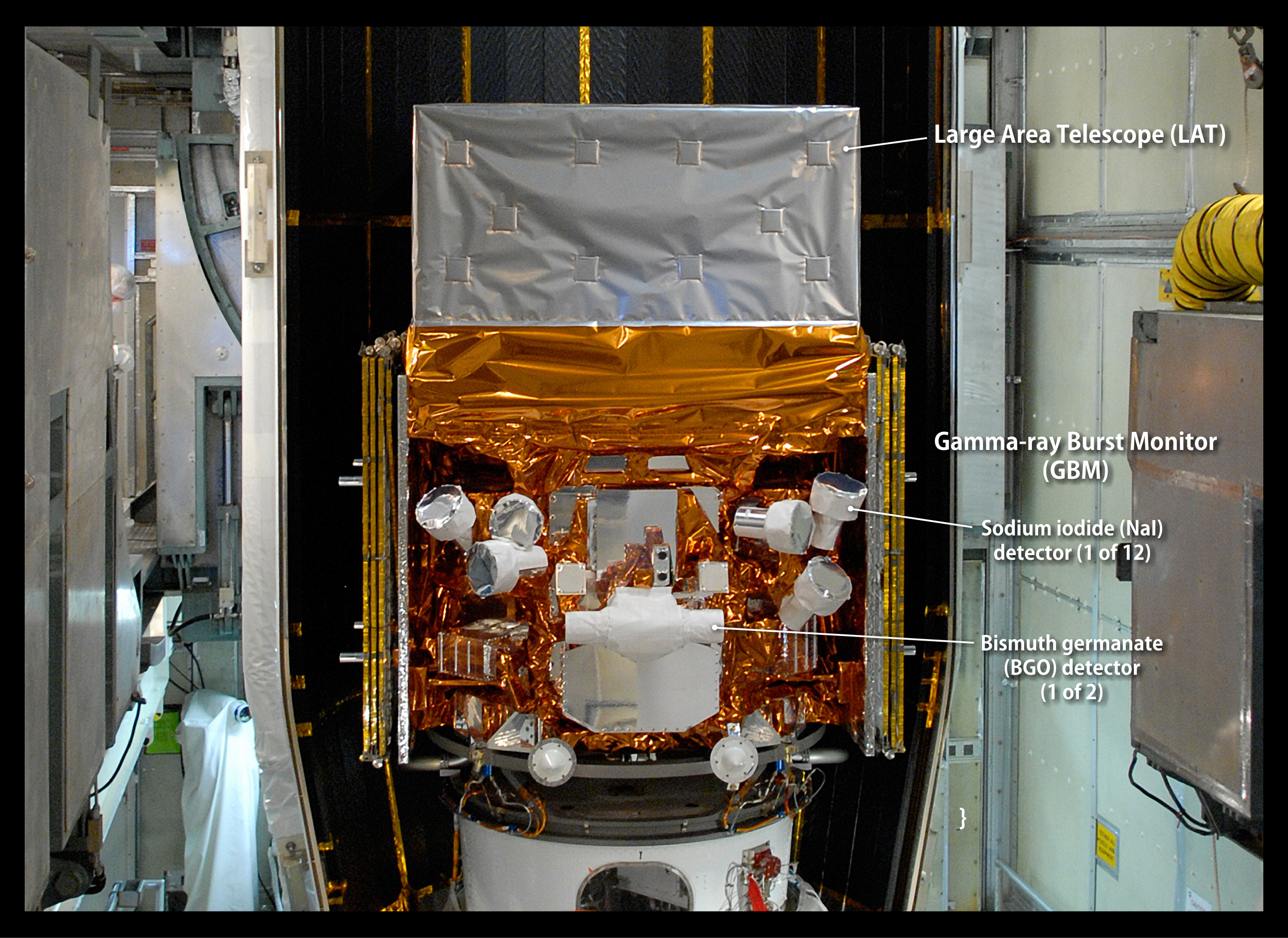 This image, taken in May 2008 as the Fermi Gamma-ray Space Telescope was being readied for launch, highlights the detectors of the spacecraft's Gamma-ray Burst Monitor (GBM). The GBM is an array of 14 crystal detectors designed for transient lower-energy gamma-ray outbursts, such as TGFs.  Labeled. Credit: NASA/Jim Grossmann