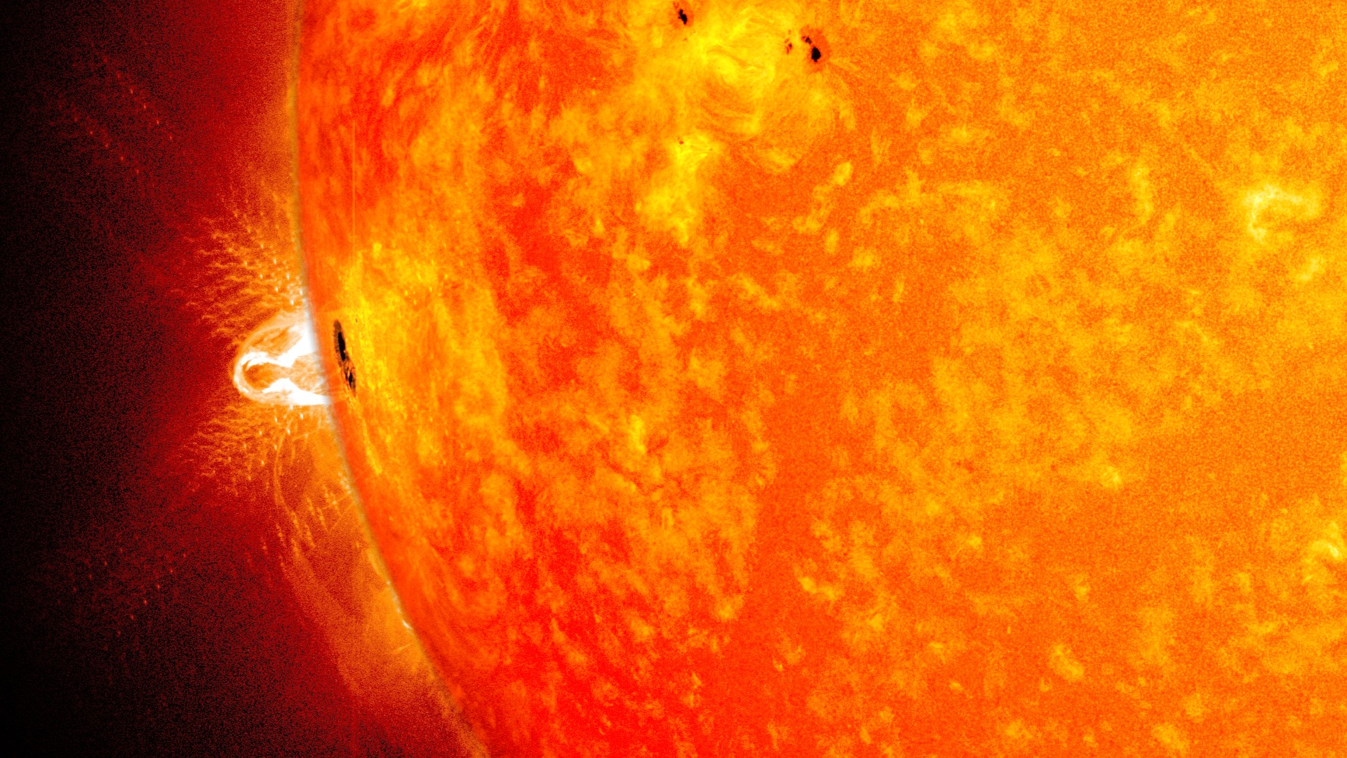 A giant sunspot appeared on Feb. 25, 2014, for its third trip across the face of the sun. This blend of two images from NASA's Solar Dynamics Observatory shows the sunspot in visible light and an X-class flare observable in ultraviolet light.Image Credit: NASA/SDO/Goddard Space Flight Center