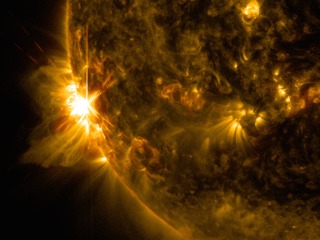 A solar flare bursts off the left limb of the sun in this image captured by NASA's Solar Dynamics Observatory on June 10, 2014, at 7:41 a.m. EDT. This is classified as an X2.2 flare, shown in a blend of two wavelengths of light: 171 and 131 angstroms, colorized in gold and red, respectively. Cropped.Image Credit: NASA/SDO/Goddard/Wiessinger