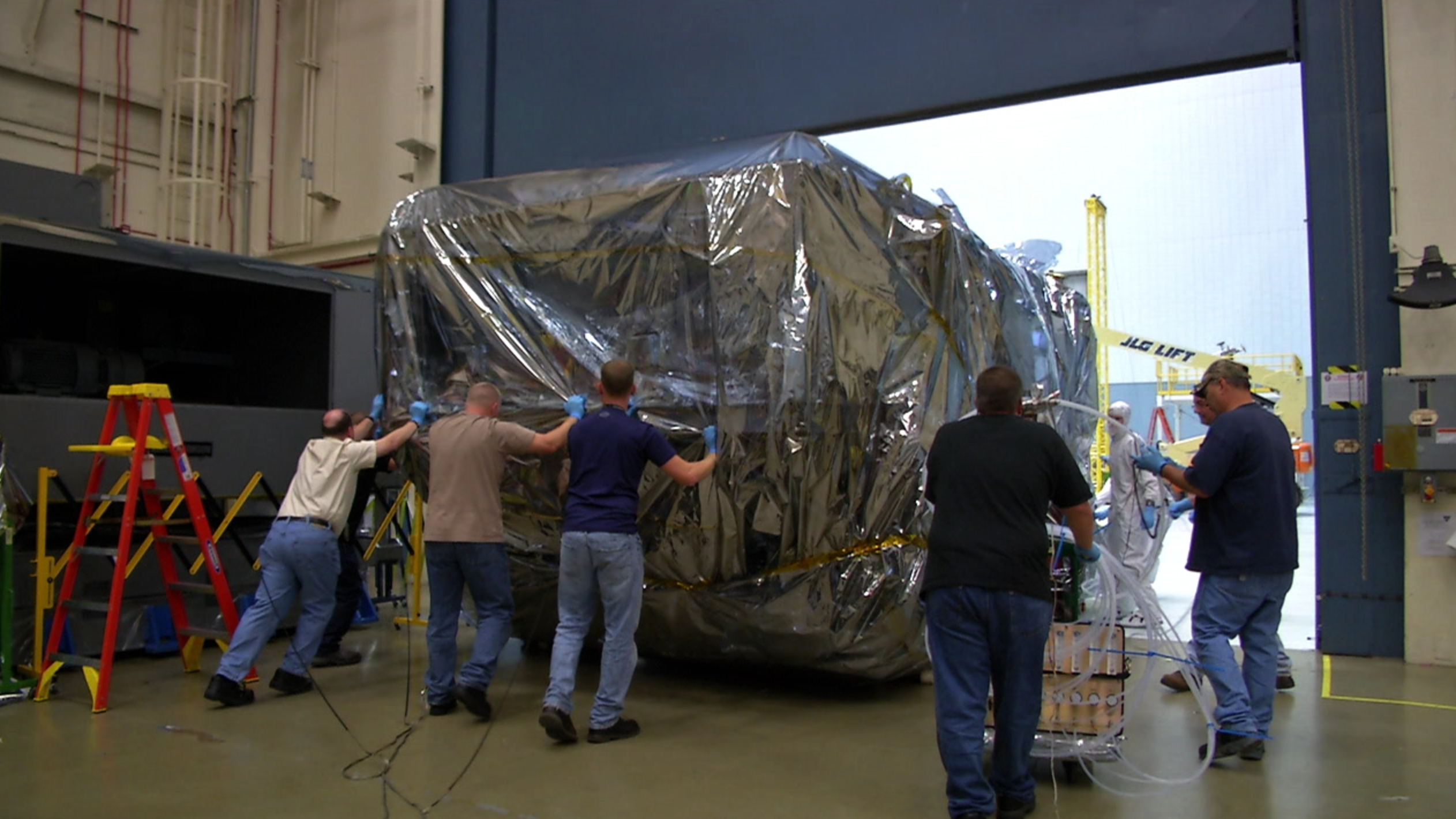 B-roll video of Webb Telescope’s ISIM structure being removed from the large cryogenic vacuum chamber at NASA Goddard Space Flight center, called the Space Environment Simulator (SES).   After ISIM is lifted out of the vacuum chamber, engineers move the wrapped ISIM structure into the clean room. 