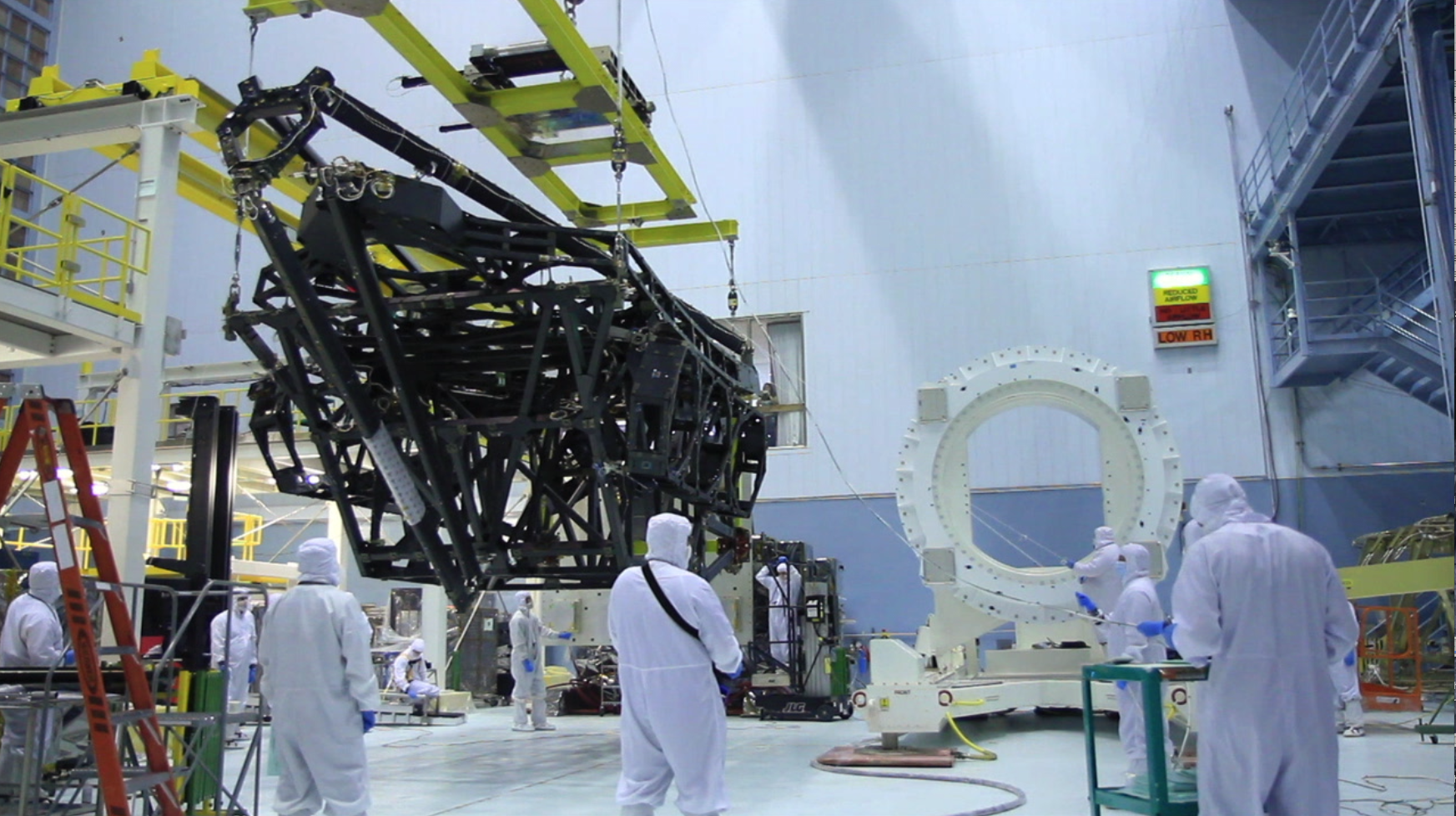 JWST backplane structure is lifted and attached to the rollover fixture at GSFC
