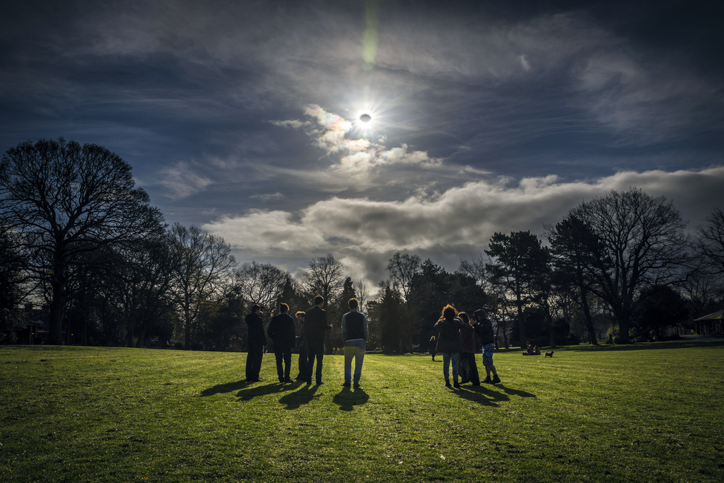 People watch a partial eclipse in Belfast, Northern Ireland, on Mar. 20, 2015. Credit: Robin Cordiner