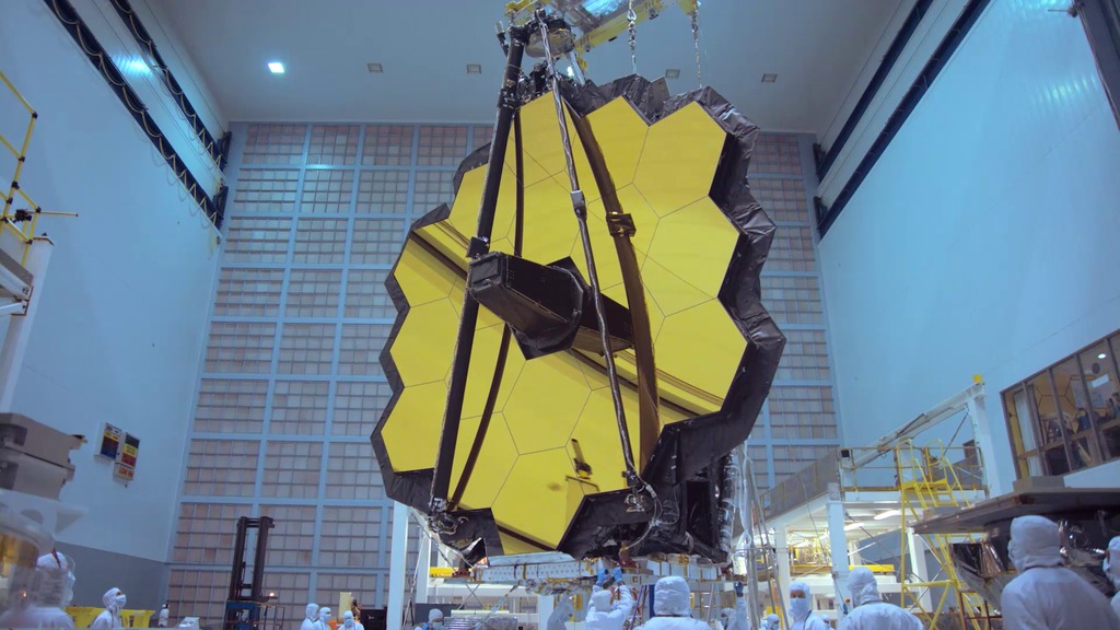 Part 2 of engineers at Goddard Space Flight Center moving the James Webb Space Telescope onto the rollover fixture, and then rotating and tilting the telescope inside the cleanroom.    