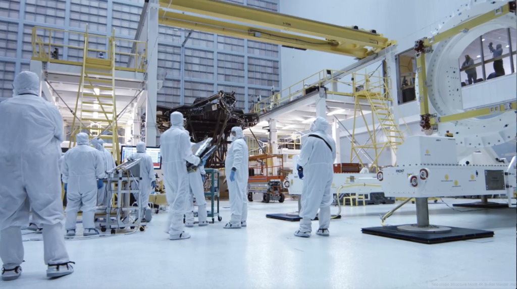 4K B-roll footage of  the Webb Telescope structure being moved from the assembly stand to the rollover fixture inside the cleanroom.