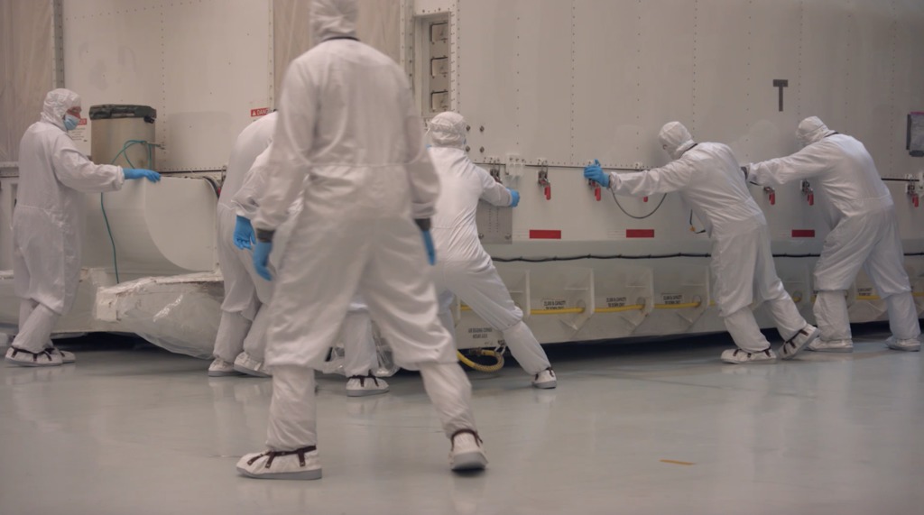 B-Roll footage of engineers at NASA's Johnson Space Center in Houston Texas moving the STTARS container into the Chamber A cleanrrom.  Once inside the cleanroom, engineers remove the lid and tent-frame from the container.   