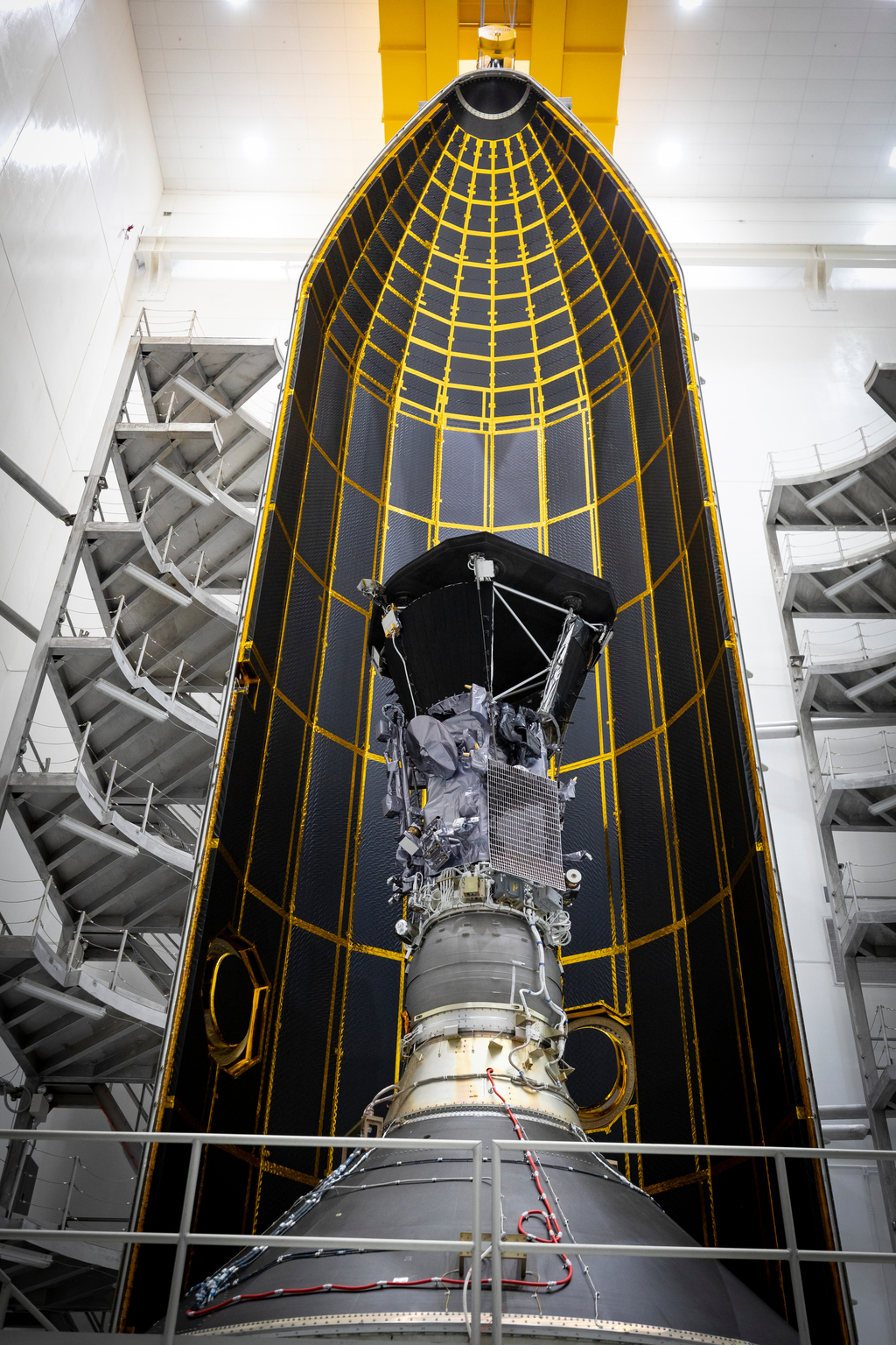 Seen here inside one half of its 62.7-foot tall fairing, NASA’s Parker Solar Probe was encapsulated on July 16, 2018, in preparation for the move from Astrotech Space Operations in Titusville, Florida to Space Launch Complex 37 on Cape Canaveral Air Force Station, where it will be integrated onto it launch vehicle, a United Launch Alliance Delta IV Heavy.Credit: NASA/Johns Hopkins APL/Ed Whitman