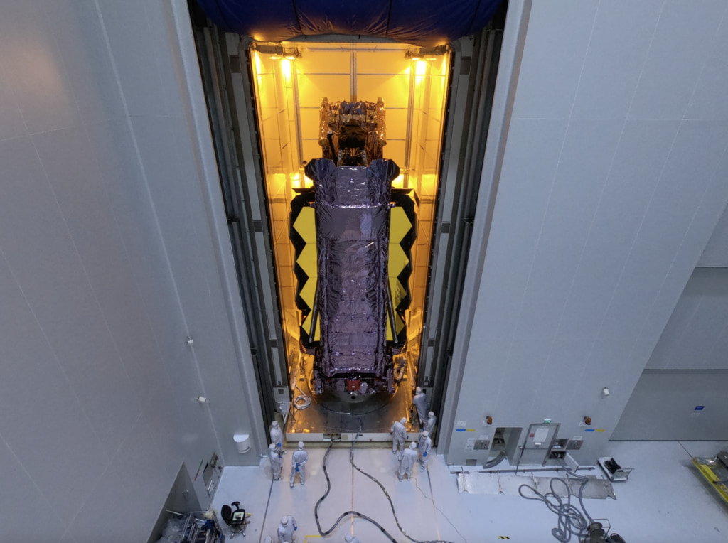 The JLG lift camera angle of the Webb Telescope being moved into a protective transport container at Guiana Space Centre in Kourou, French Guiana.
