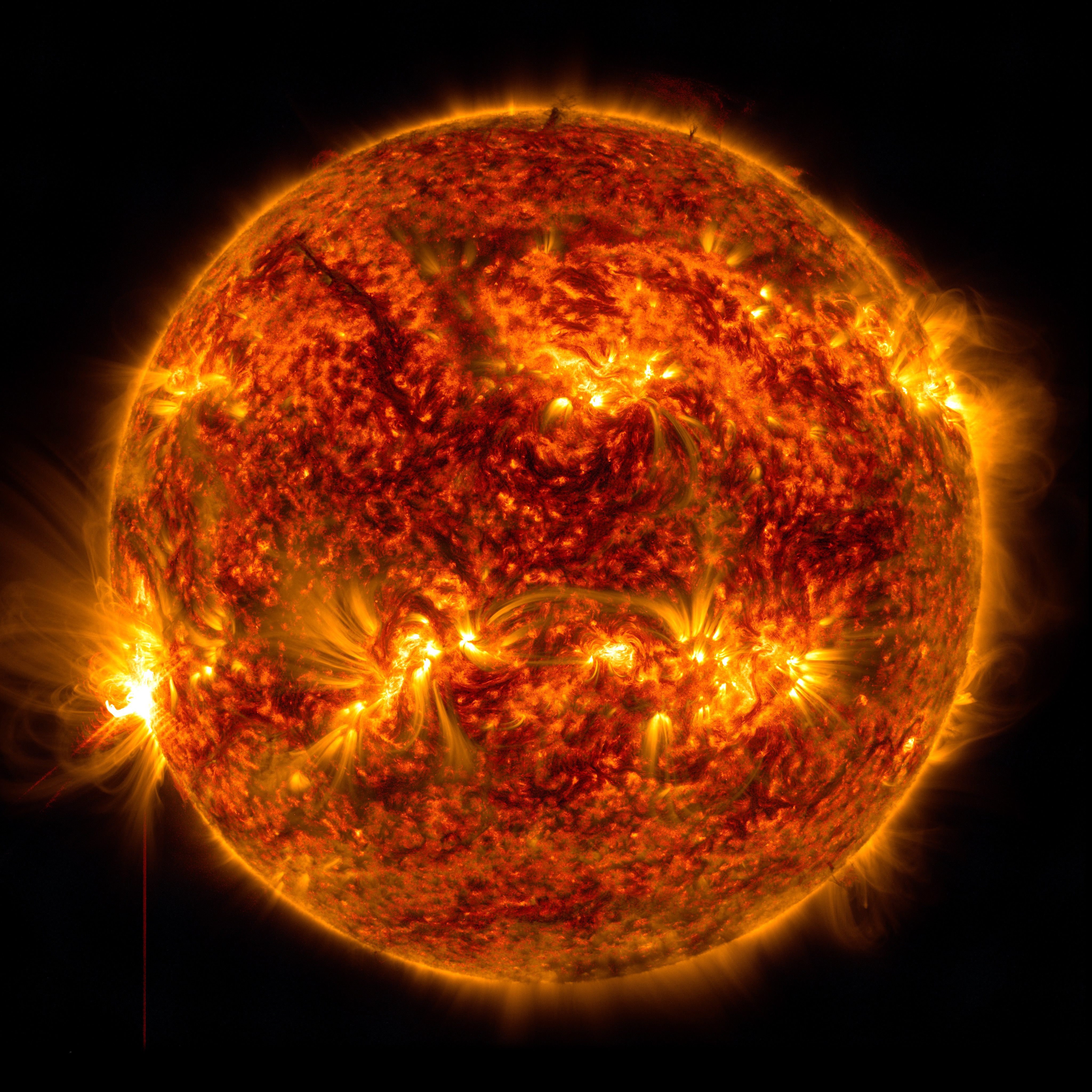 An X1.2 class solar flare flashes on the left edge of the Sun on January 5, 2023. This image was captured by NASA's Solar Dynamics Observatory and shows a blend of light from the 171 and 304 angstrom wavelengths.Credit: NASA/GSFC/SDO