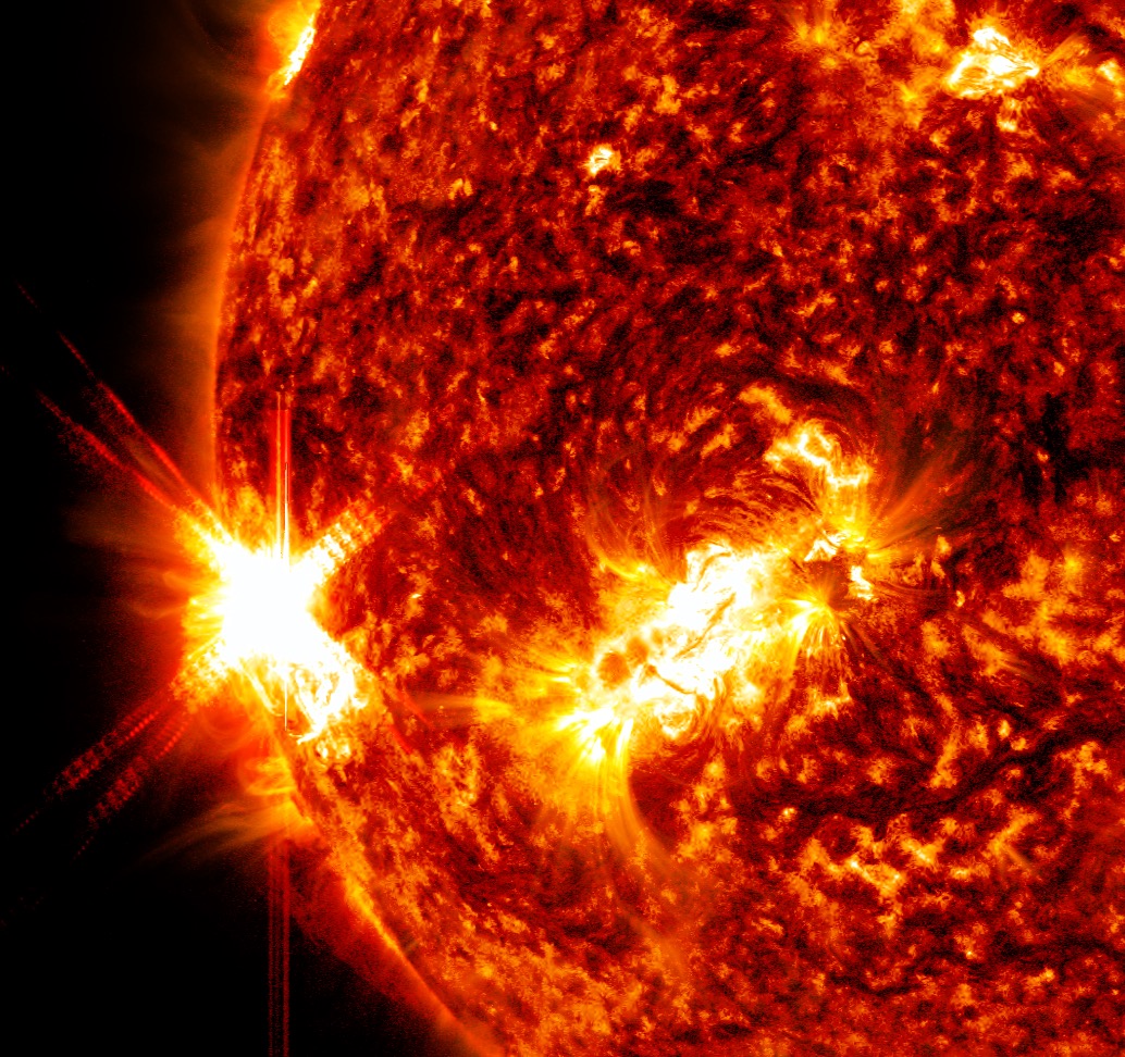 An X1.9 class solar flare flashes on the left edge of the Sun on January 9, 2023. This image was captured by NASA's Solar Dynamics Observatory and shows a blend of light from the 171, 131 and 304 angstrom wavelengths.Credit: NASA/GSFC/SDO
