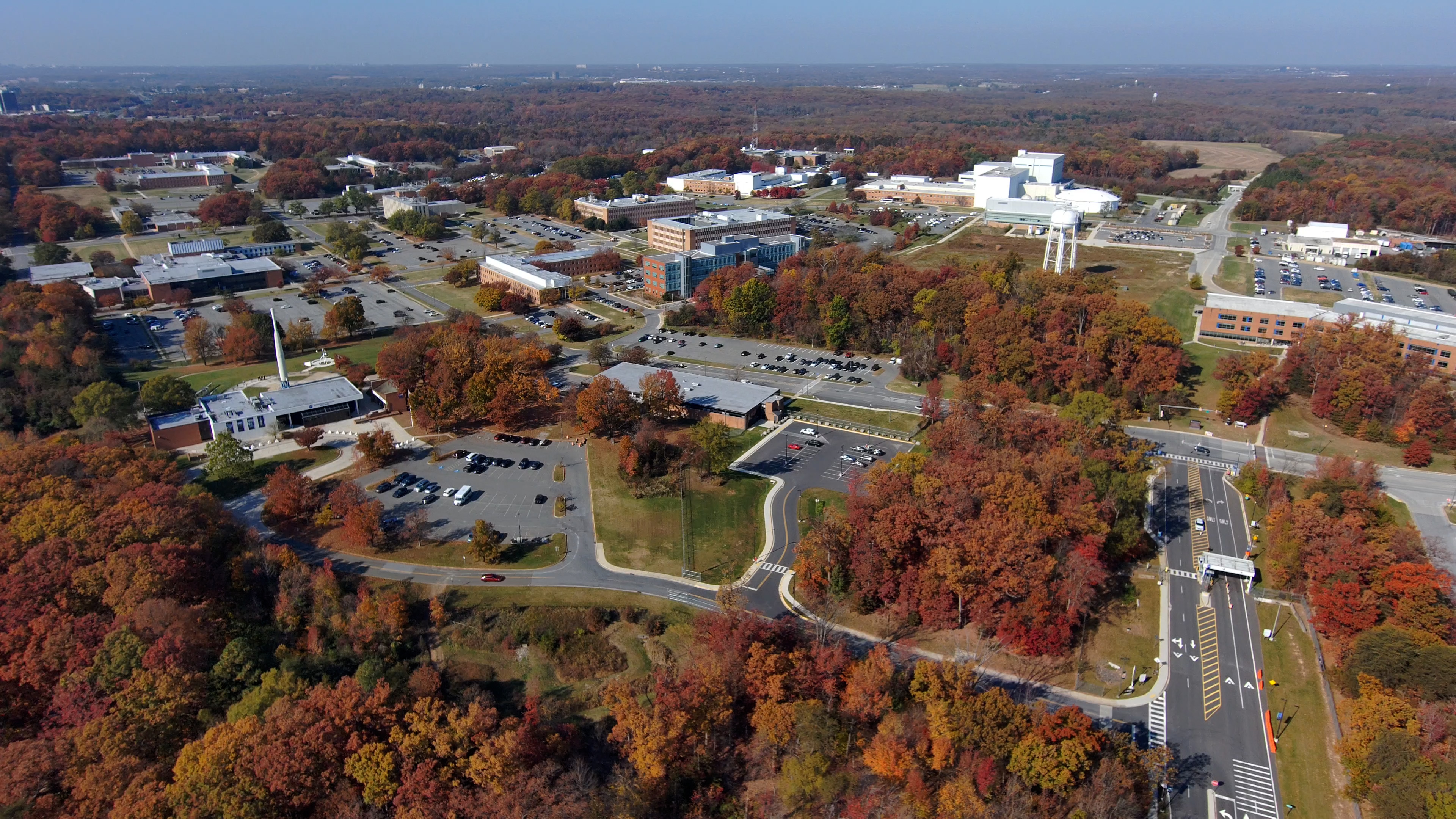 Two 180-degree pans from above the Goddard Main Gate sign in midday sun and fall colors. The first is fairly slow, the return pan is faster. Greenbelt Road is prominent at the start and end. Captured Nov. 9, 2023.Credit: NASA/Francis Reddy