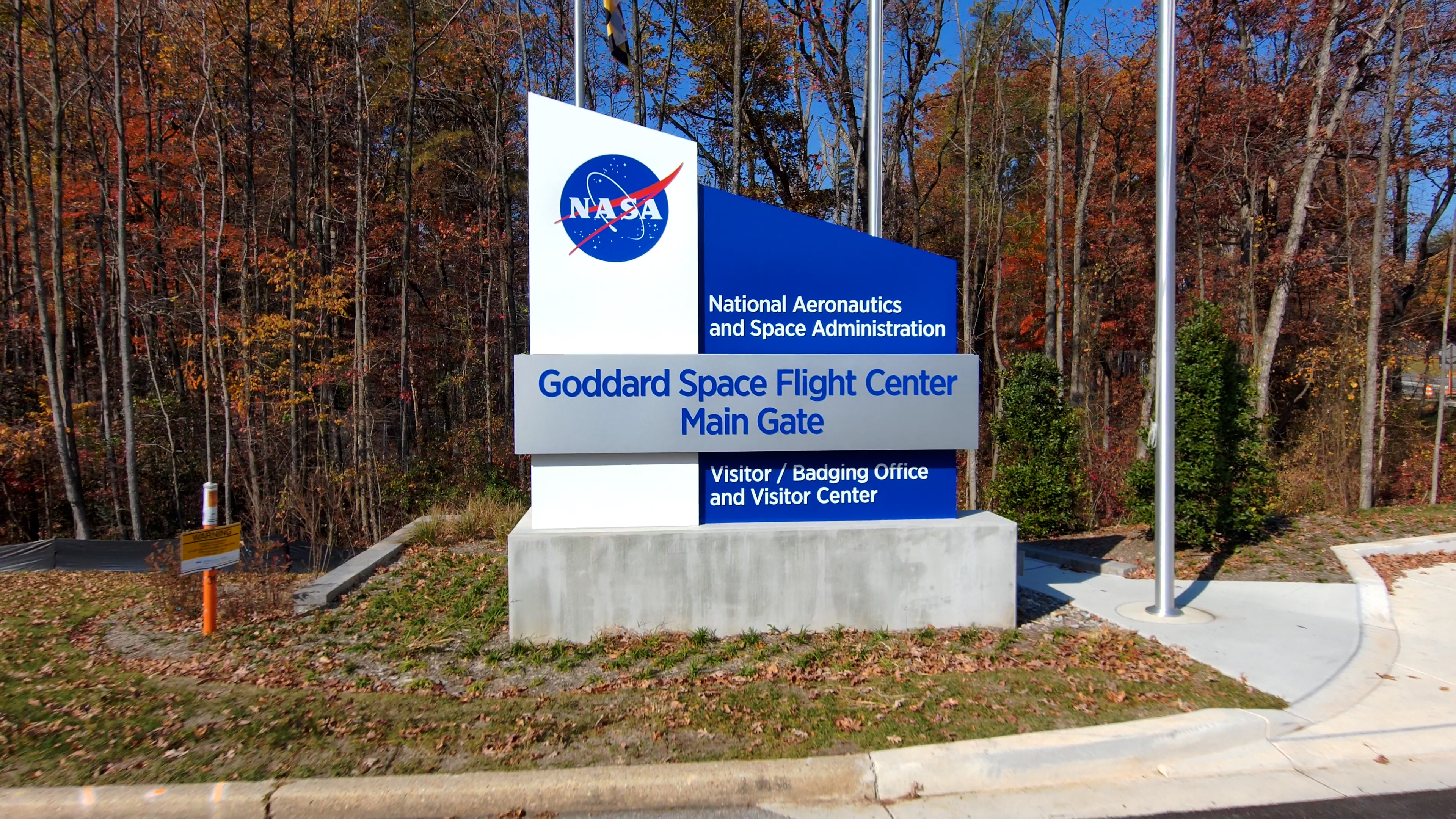 Views of the Goddard Main Gate sign. The first clip shows the sign up close, then the camera pulls back swiftly. The other clips begin close to the sign and rise over the center at different speeds, looking northwest. Captured Nov. 9, 2023.Credit: NASA/Francis Reddy