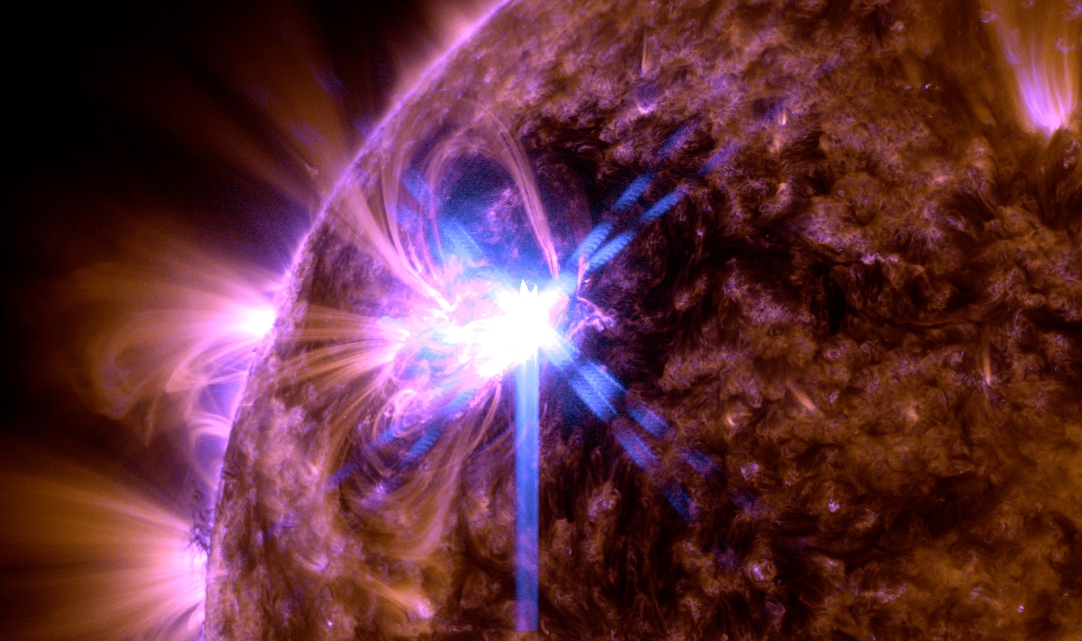 NASA’s Solar Dynamics Observatory captured this image of a solar flare – as seen in the bright flash on theupper left – on Feb. 21, 2024. The image shows a blend of 171 Angstrom and 131 Angstrom light, subsets of extreme ultraviolet light that highlight the plasma loops in the corona and the extremely hot material in flares, respectively. Cropped to highlight the flaring region. Credit: NASA/SDO