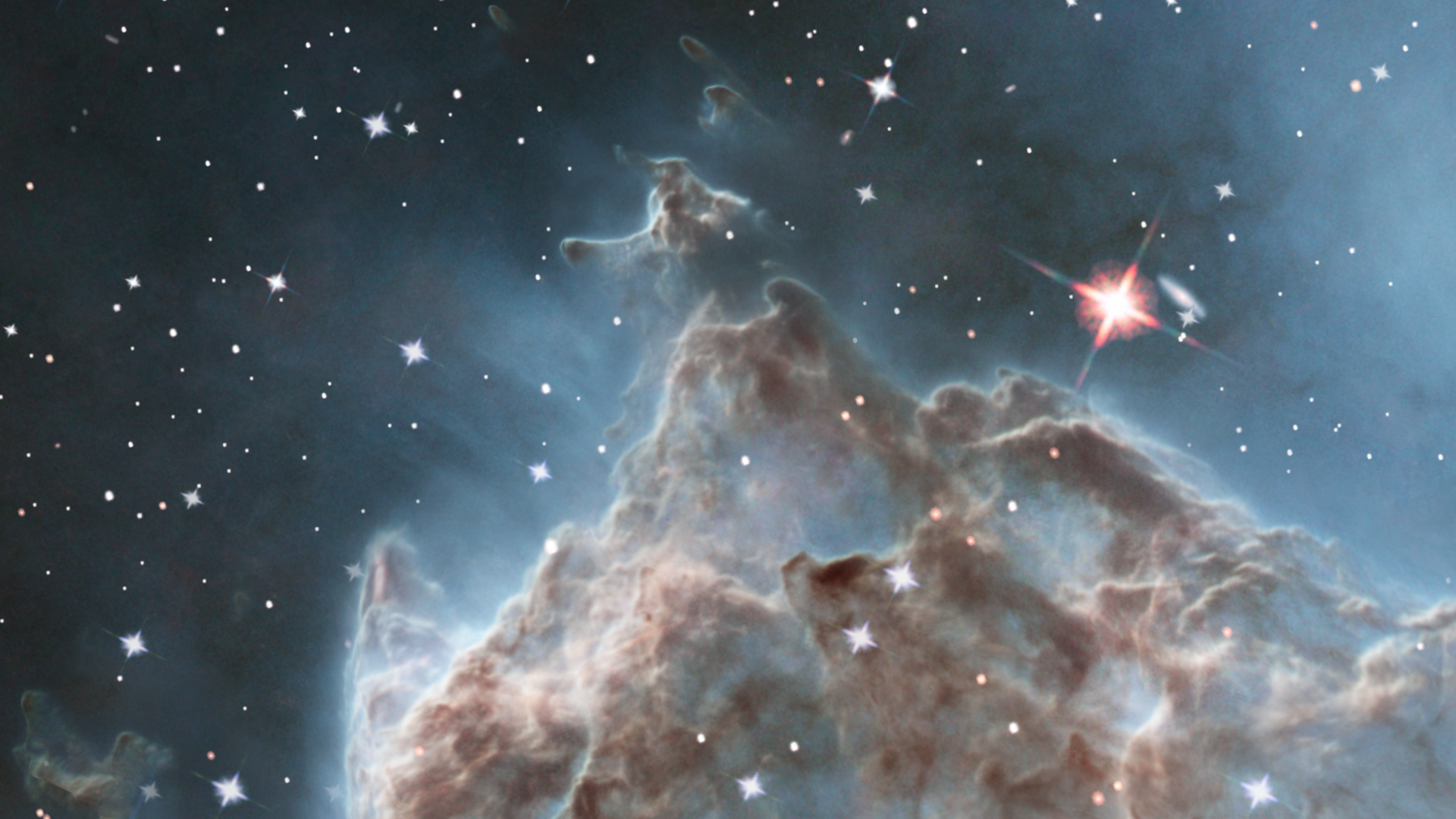This scientific visualization zooms from the night sky to some pillars in the Monkey Head Nebula (aka NGC 2174). After cross-fading to an infrared view, the sequence showcases the 3D nature of these gaseous peaks.